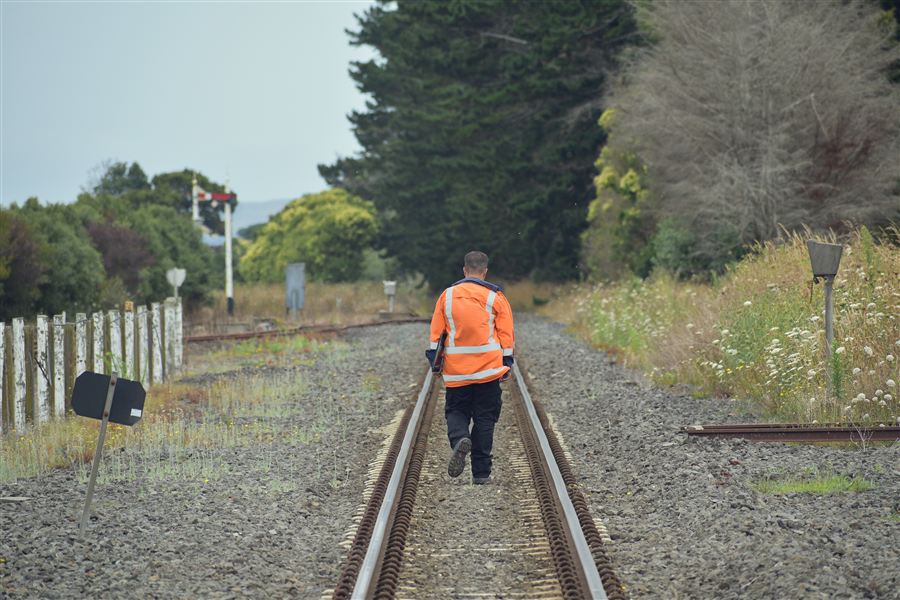 Railway track worker walking the line