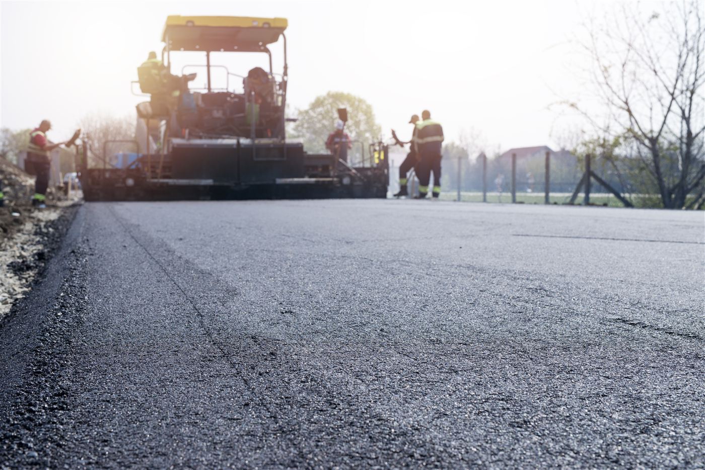 Asphalt coating being laid on road